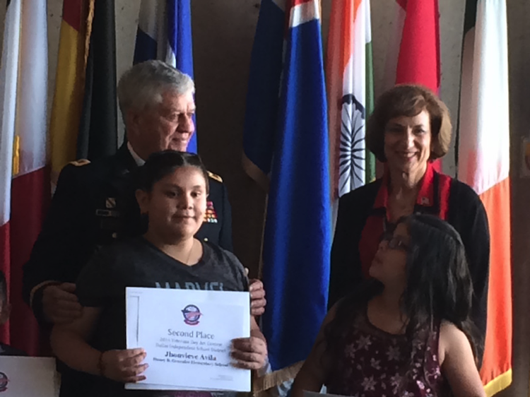 COL Ron Forest presents awards to the Winners of Children Patriotic Art Contest at Veterans Day Pre-Parade Ceremony